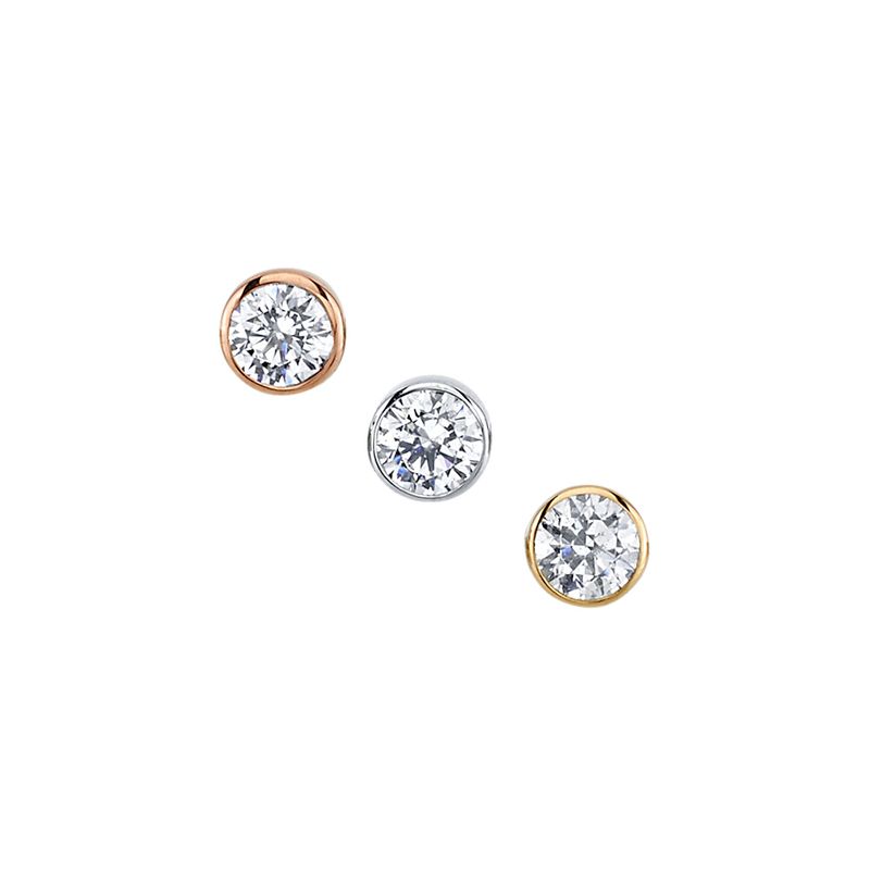 Set of three bezel-set diamond piercing pins in rose gold, white gold, and yellow gold