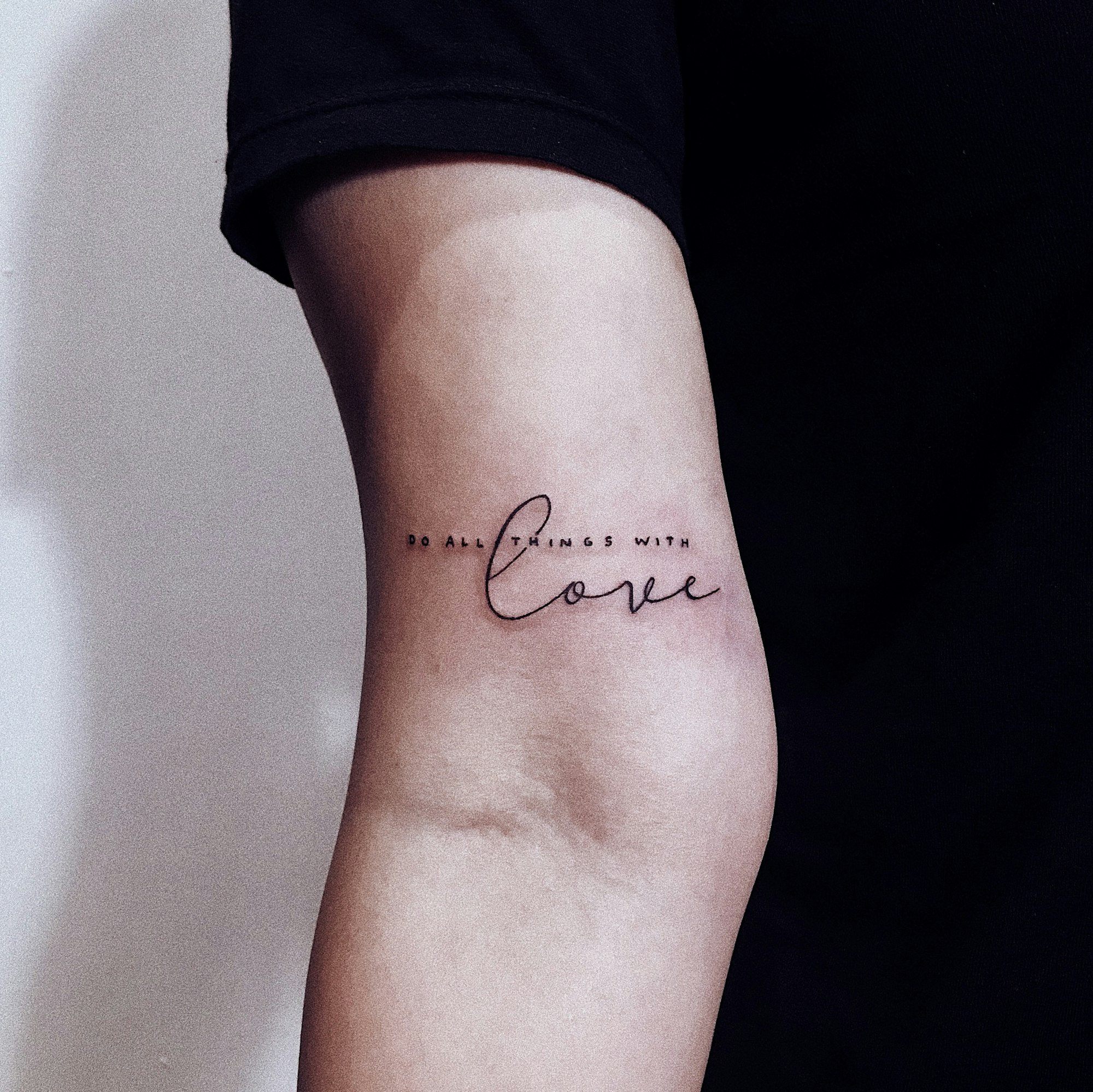 Close-up of a detailed color tattoo sleeve with banner script and traditional linework